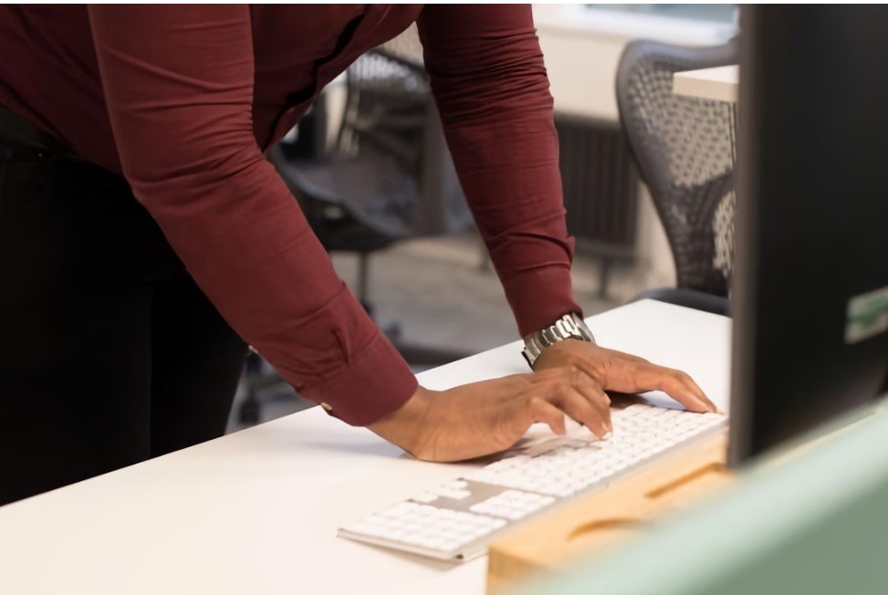 A person typing on a computer keyboard, illustrating AI integration for knowledge management by BA Insight.